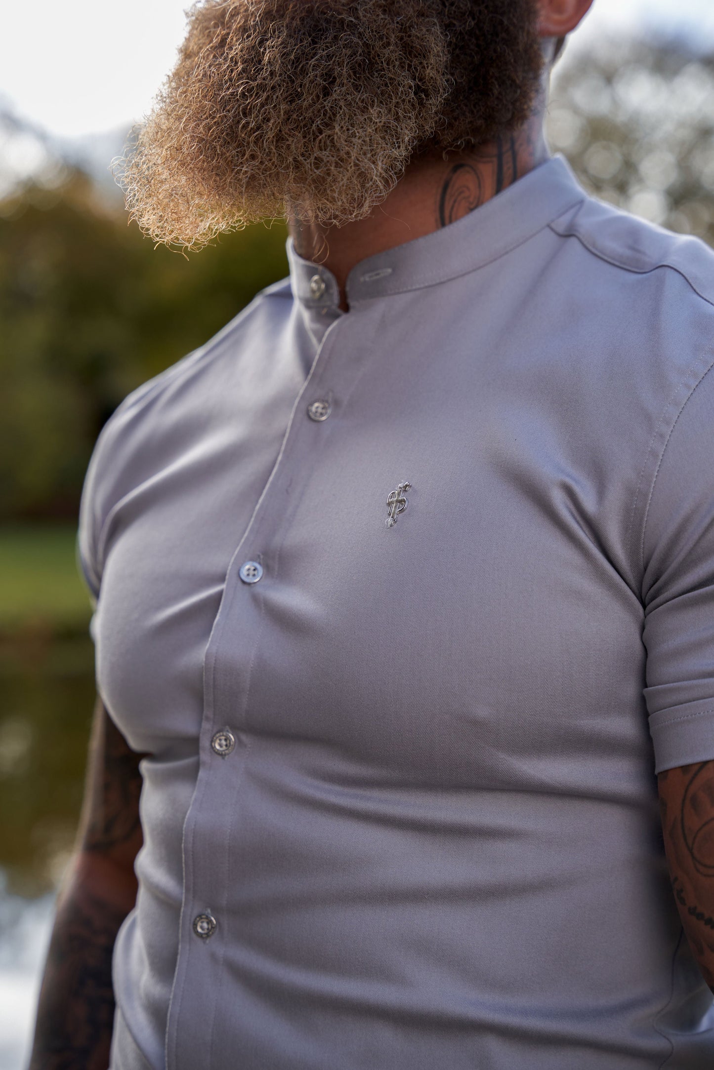 Elevate Your Wardrobe with Father Sons Super Slim Stretch Grey Denim Short Sleeve Shirt Featuring a Stylish Grandad Collar, Sleek Silver Metal Buttons, and Eye-Catching Decal - FS963