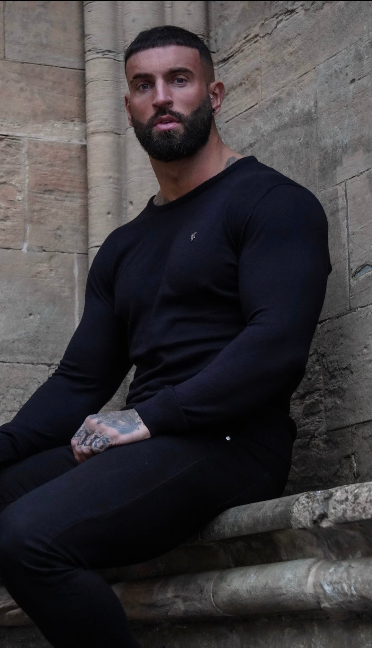 Elevate Your Style with the Father Sons Classic Black Knitted Crew Neck Jumper Featuring a Sleek Metal Decal - FSN086
